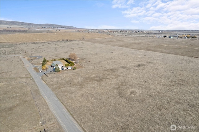 drone / aerial view with a mountain view and a rural view