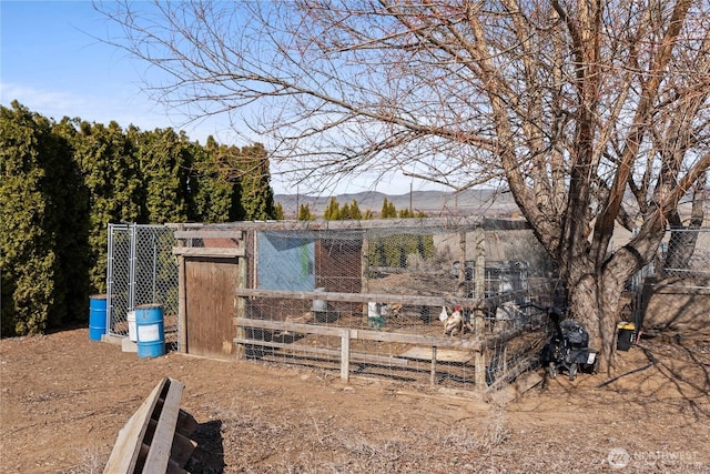 view of yard with a mountain view, an outdoor structure, and exterior structure