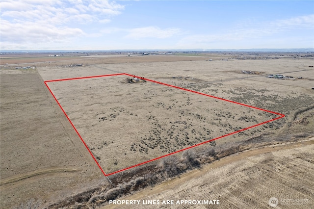 drone / aerial view featuring a desert view and a rural view