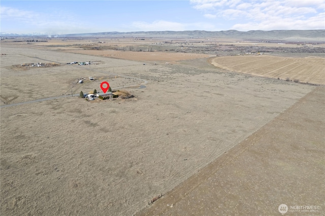 bird's eye view with a desert view, a mountain view, and a rural view