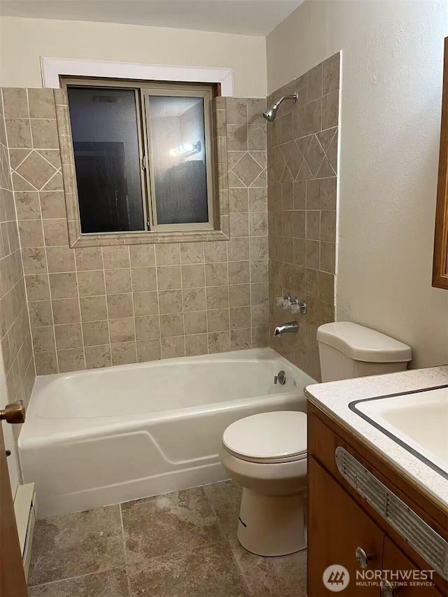 bathroom featuring vanity, shower / bathing tub combination, toilet, and baseboard heating