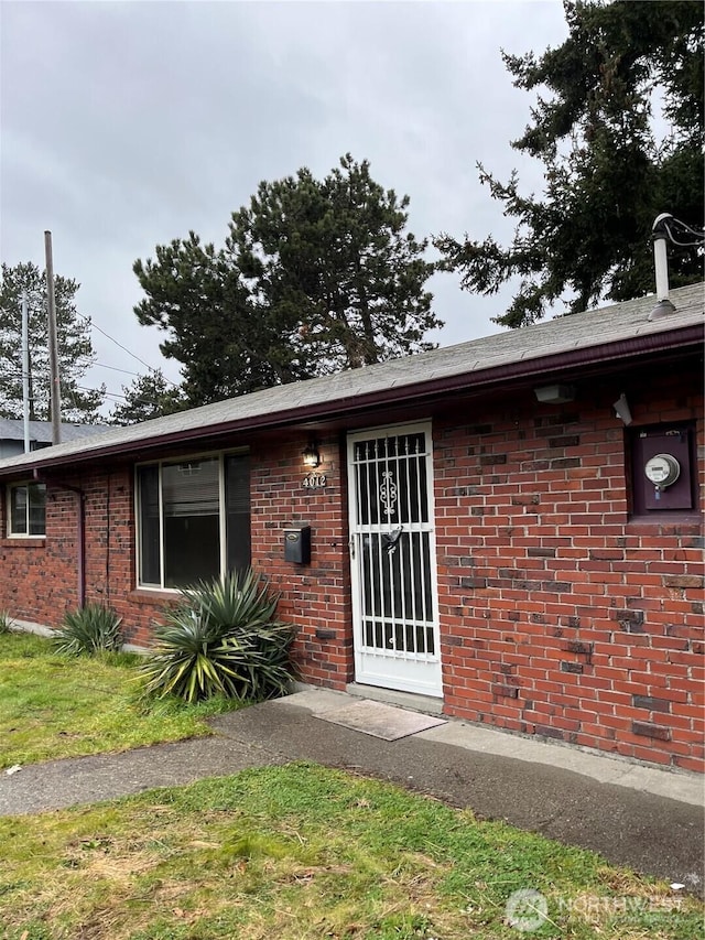 entrance to property with brick siding