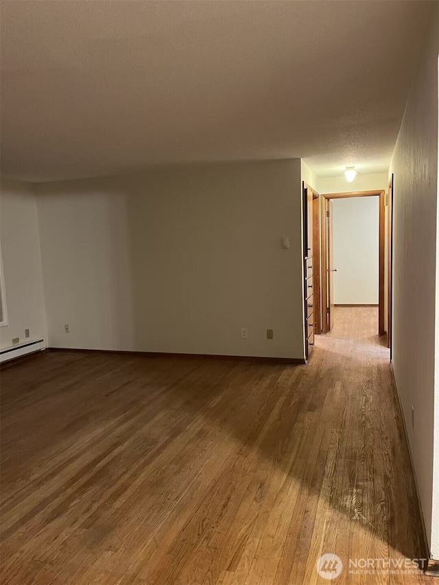 spare room featuring wood finished floors