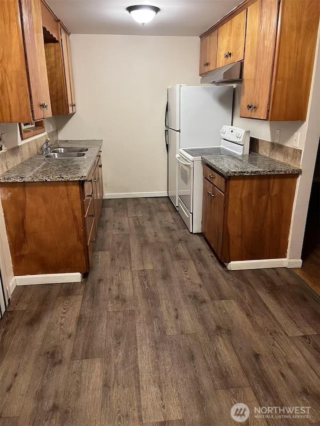 kitchen with dark wood-style floors, white electric stove, a sink, under cabinet range hood, and brown cabinets