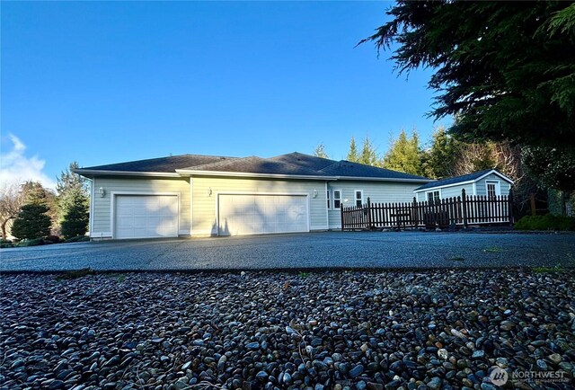 50 Holbrook Ln, Aberdeen, WA 98520 - view of front of property featuring gravel driveway, an attached garage, and fence