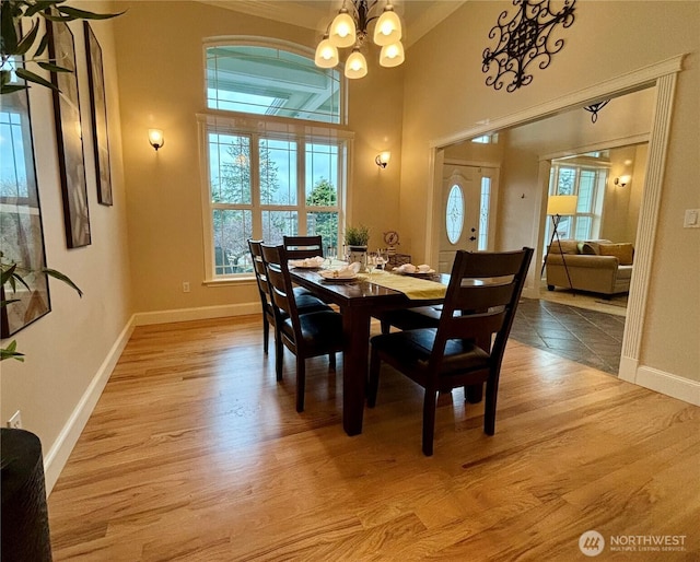 50 Holbrook Ln, Aberdeen, WA 98520 - dining area featuring a notable chandelier, a healthy amount of sunlight, and light wood-type flooring