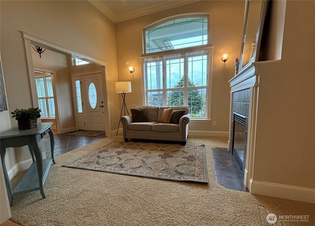 50 Holbrook Ln, Aberdeen, WA 98520 - carpeted entrance foyer with a fireplace, baseboards, crown molding, and a towering ceiling