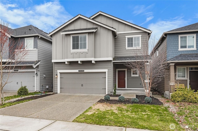 view of front of house with an attached garage, board and batten siding, and driveway