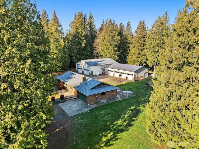 birds eye view of property featuring a view of trees