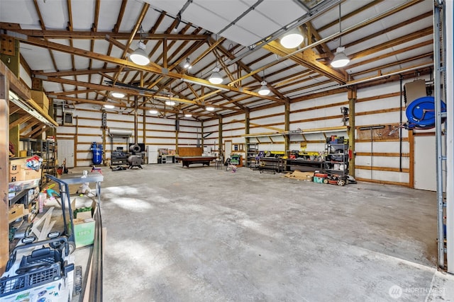 garage featuring a workshop area and metal wall