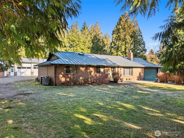 ranch-style house featuring a standing seam roof, a chimney, a front lawn, crawl space, and metal roof