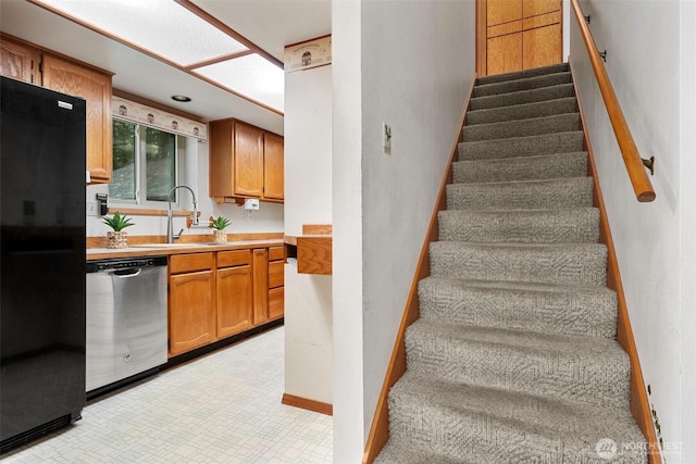 stairs featuring tile patterned floors and baseboards