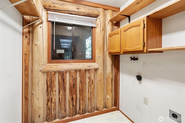 washroom featuring cabinet space, hookup for an electric dryer, and light floors