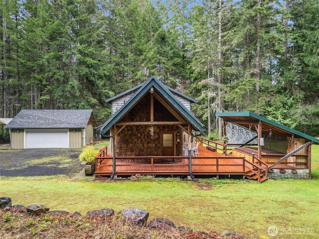 exterior space with an outbuilding, covered porch, a detached garage, and a yard