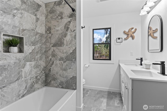 bathroom featuring a sink, baseboards, toilet, and marble finish floor