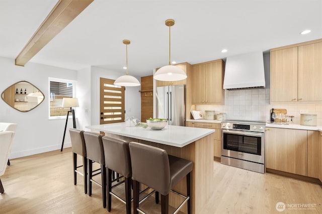 kitchen featuring light brown cabinets, a breakfast bar, custom exhaust hood, stainless steel appliances, and backsplash