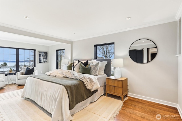 bedroom featuring recessed lighting, baseboards, light wood-style flooring, and crown molding