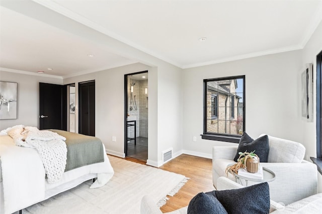 bedroom featuring visible vents, light wood-type flooring, baseboards, and ornamental molding