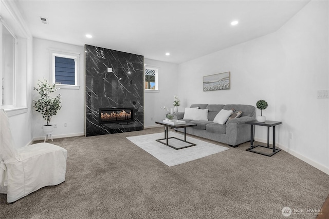 carpeted living room featuring recessed lighting, a fireplace, and baseboards