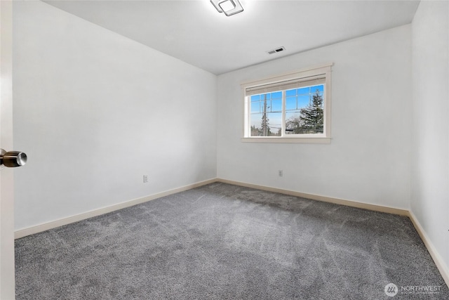 carpeted empty room featuring baseboards and visible vents