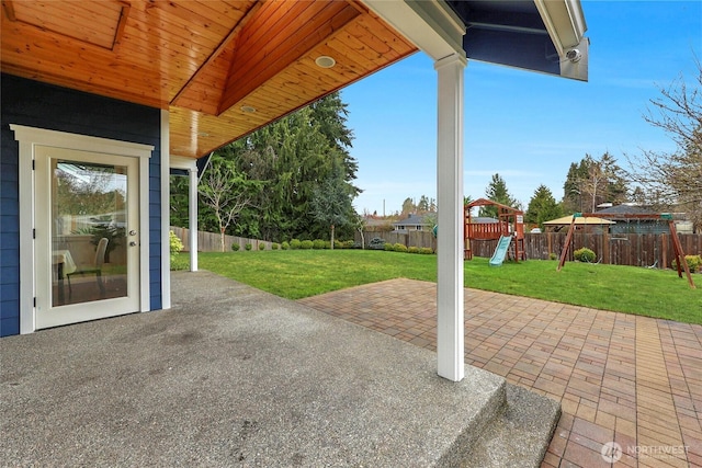 view of patio featuring a playground and a fenced backyard