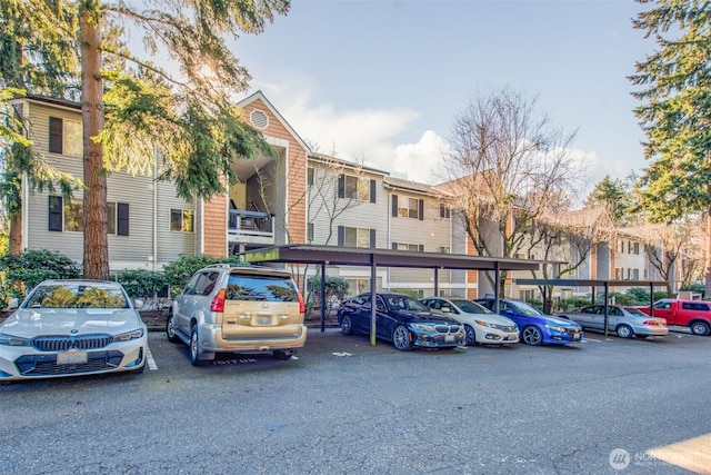 view of property with covered and uncovered parking