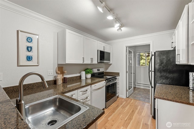 kitchen featuring a sink, stainless steel appliances, white cabinetry, crown molding, and light wood-type flooring