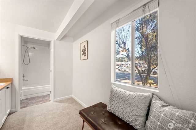 sitting room featuring light colored carpet and baseboards