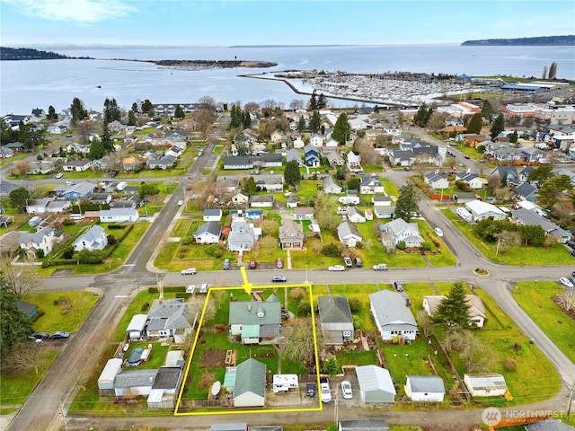 birds eye view of property with a residential view and a water view