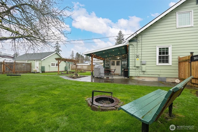 view of yard with a patio area, an outdoor fire pit, a pergola, and a fenced backyard