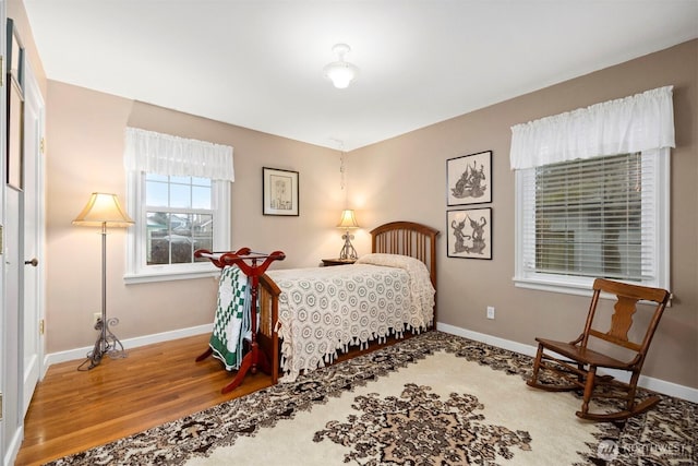 bedroom featuring baseboards and wood finished floors