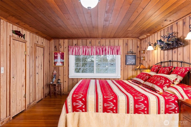 bedroom with wooden walls, wood ceiling, and wood finished floors