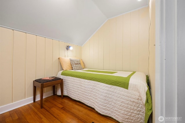 bedroom with lofted ceiling and hardwood / wood-style flooring