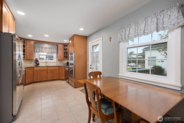 dining area with recessed lighting and light tile patterned floors