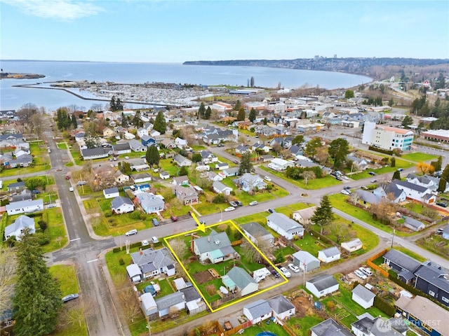 birds eye view of property with a residential view and a water view