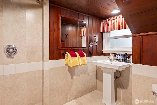 bathroom featuring wooden walls, wood ceiling, and a shower