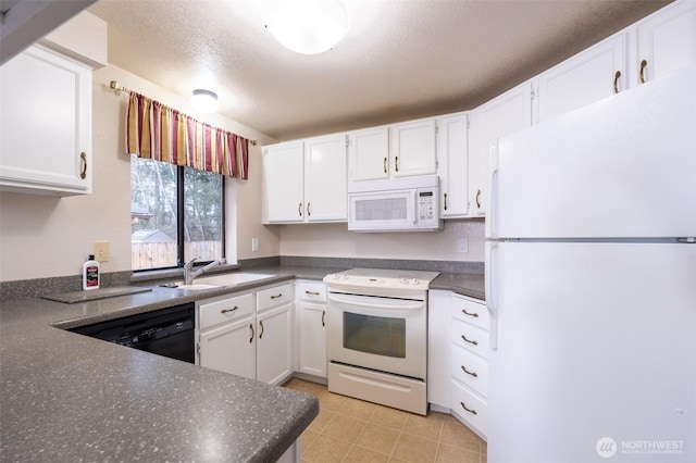 kitchen featuring a sink, white appliances, dark countertops, and white cabinetry