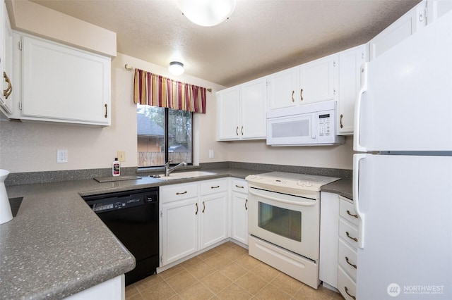 kitchen featuring a sink, white appliances, dark countertops, and white cabinets