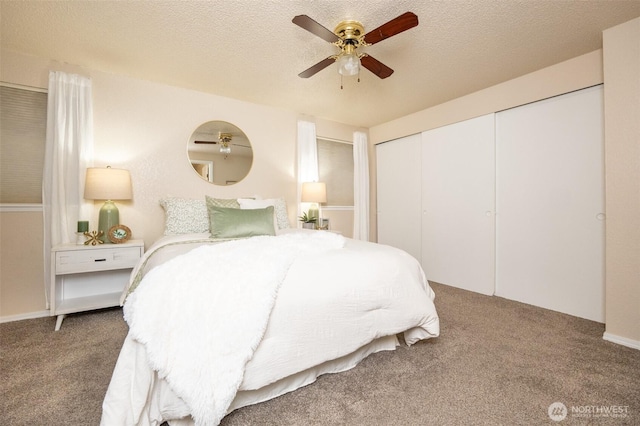 carpeted bedroom with a closet, a textured ceiling, and a ceiling fan