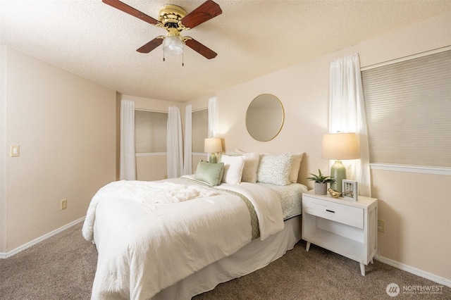 bedroom featuring a textured ceiling, baseboards, and carpet