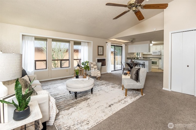 carpeted living area featuring baseboards, lofted ceiling, a textured ceiling, and ceiling fan