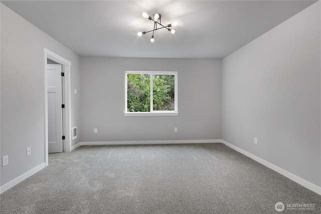 carpeted spare room with baseboards and visible vents