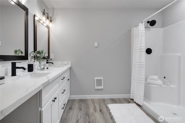 full bathroom featuring visible vents, curtained shower, wood finished floors, and a sink