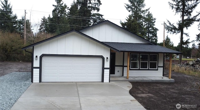 view of front of house with an attached garage, concrete driveway, roof with shingles, and board and batten siding