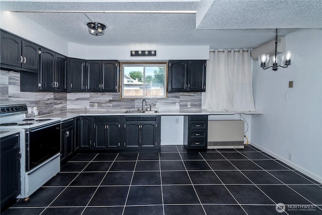 kitchen featuring range with electric cooktop, dark tile patterned floors, a sink, tasteful backsplash, and light countertops