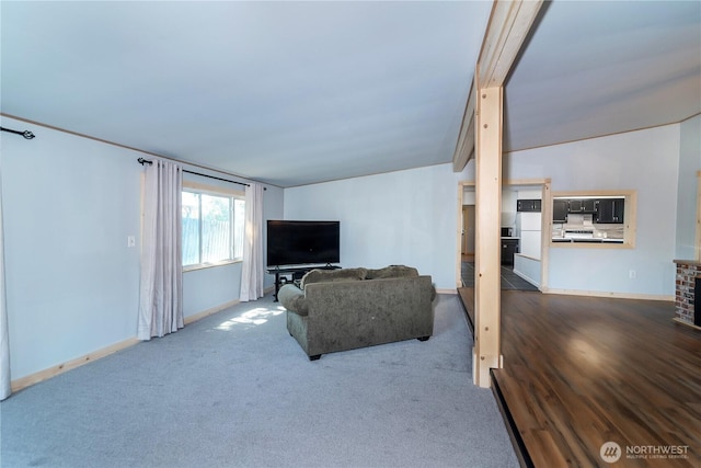 living room featuring carpet flooring and baseboards