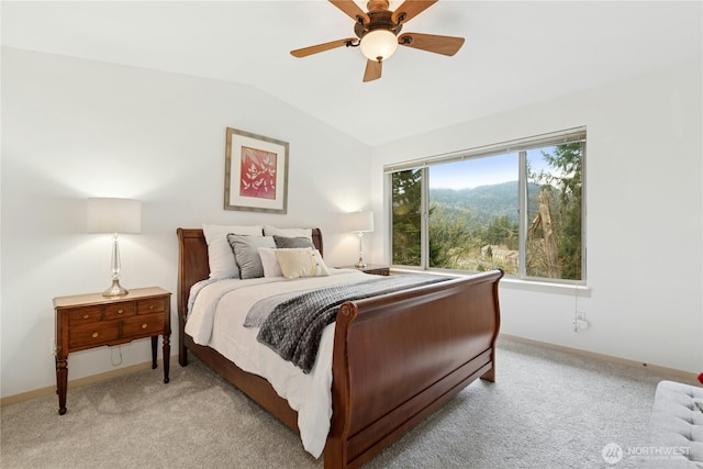 bedroom featuring lofted ceiling, light colored carpet, and baseboards