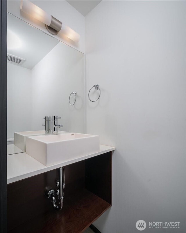 bathroom with vanity and visible vents