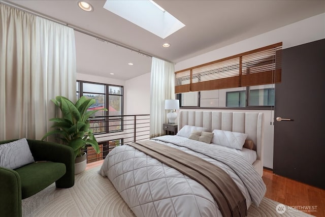 bedroom featuring recessed lighting, wood finished floors, and a skylight