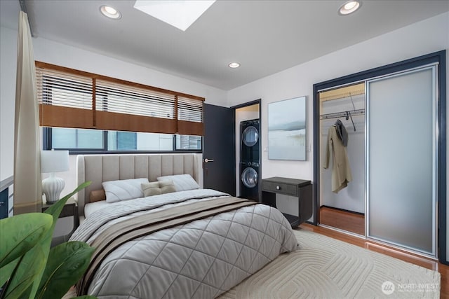 bedroom with recessed lighting, a skylight, and wood finished floors